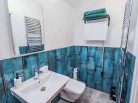 A bathroom with a sink and toilet at The Joiners Cottage in Birling near Warkworth
