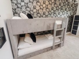 A bunk bed with pillows and sheets at The Joiners Cottage in Birling near Warkworth