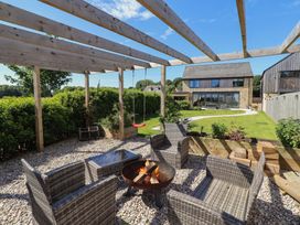 A garden with seating and a fire pit at The Joiners Cottage in Birling near Warkworth