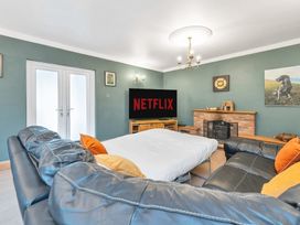 A living room with a sofa and television at Oldfields