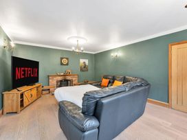 A living room with a sofa and television at Oldfields