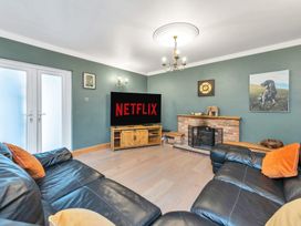 A living room with a television and fireplace at Oldfields