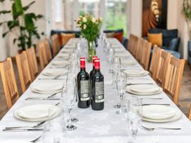 A dining room with a long table set for a meal at Oldfields