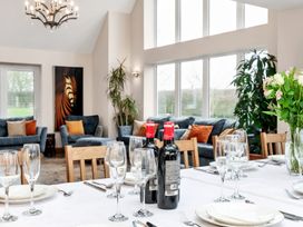 A dining room with a table set and wine bottles at Oldfields 
