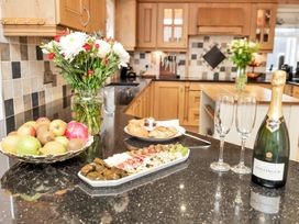 A kitchen with food and drinks on the counter at Oldfields