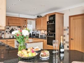 A kitchen with wooden cabinets and a fruit bowl at Oldfields