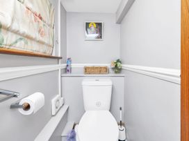 A bathroom featuring a white toilet and wall art at Oldfields