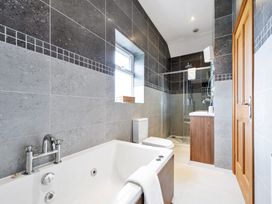 A bathroom featuring a bathtub, toilet, shower, and sink at Oldfields