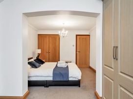 A bedroom with a bed and wardrobe at Oldfields