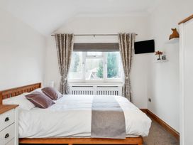 A bedroom with a bed and window at Oldfields 