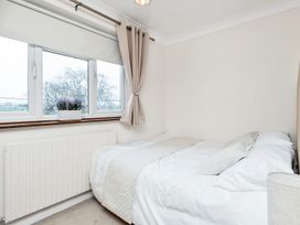 A bedroom with a bed and windows at Oldfields