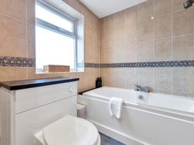 A bathroom with a bathtub and toilet at Oldfields in 