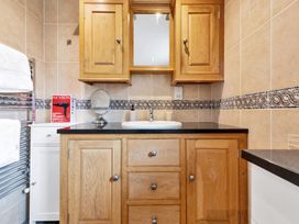 A bathroom with a sink and wooden cabinets at Oldfields