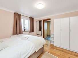 A bedroom with a bed and wardrobe at Oldfields