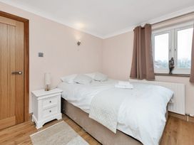 A bedroom with a bed and bedside table at Oldfields