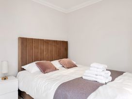 A bedroom with a bed and towels on the side at Oldfields