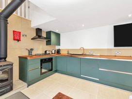 A kitchen with stove and cabinetry at Oldfields