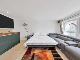 A living room with a sofa bed and cabinet at Oldfields