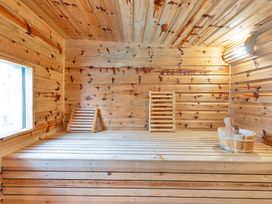 A sauna with wooden benches and a window at Oldfields