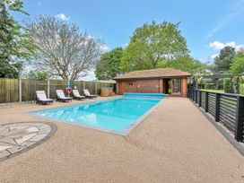 An outdoor area with a swimming pool and loungers at Oldfields