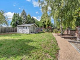 A garden with a shed and trees at Oldfields, Bury St Edmunds