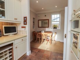 A dining room with a table and chairs at Bryniau in Pwllheli