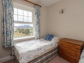A bedroom with a single bed and a chest of drawers at Bryniau in Pwllheli