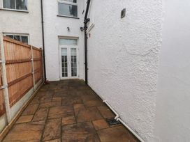 An outdoor area with a stone pathway and a door at Bryniau Pwllheli