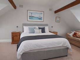 A bedroom with a bed and bedside tables at Bryniau in Morfa Nefyn