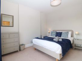 A bedroom with a bed and furniture at Bryniau in Morfa Nefyn