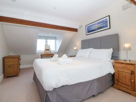 A bedroom with a bed and nightstands at Bryniau in Morfa Nefyn