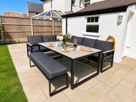 An outdoor dining area with table and seating at Bryniau Morfa Nefyn
