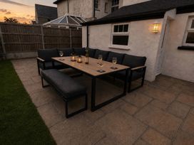 A dining area with seating and drinks at Bryniau Morfa Nefyn