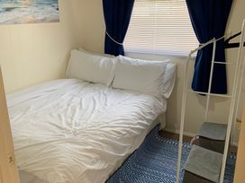 A bedroom with a bed and window at 187 Atlantic Bays Tregolds