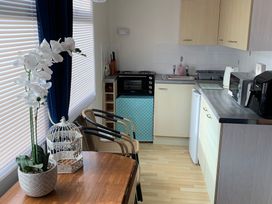 A kitchen with table and chairs at 187 Atlantic Bays in Tregolds