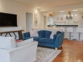 A living room with a blue sofa and tv at Devona in Beer