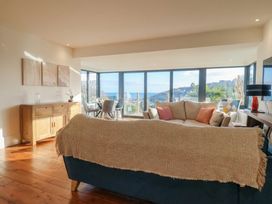 A living room with a sofa and wooden cabinet at Devona in Beer