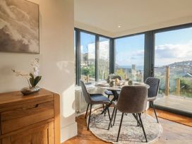 A dining room with a table and chairs at Devona in Beer