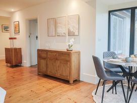A dining room with a sideboard and a table at Devona in Beer