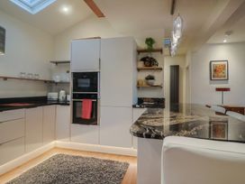 A kitchen with modern appliances and a bar counter at Devona in Beer
