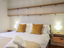 A bedroom featuring a bed with pillows and a nightstand at Devona in Beer