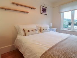 A bedroom with a bed and bedside table at Devona in Beer