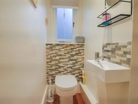 A bathroom with a toilet and sink at Devona in Beer