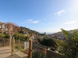 A view of houses and ocean from a deck in Devona Beer
