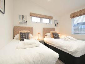 A bedroom with two beds and wall art at 20 Meadow Retreat in Dobwalls