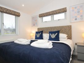 A bedroom with a bed and decorative pillows at 20 Meadow Retreat in Dobwalls