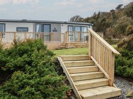 An exterior view of a property with steps and decking at Willow's Way in Stranraer