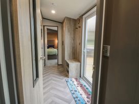 A hallway with a bench and window at Willow's Way in Stranraer