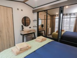 A bedroom with a bed and towels on top at Willow's Way in Stranraer