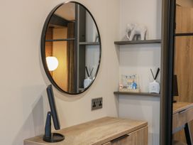 An office with a mirror, shelf, and decorative items at Willow's Way in Stranraer